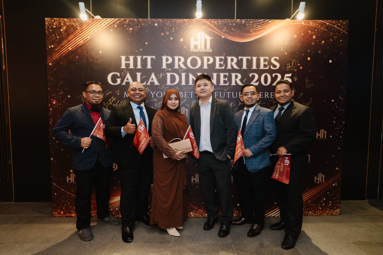 A group posing in front of the HIT Properties Gala Dinner 2025 backdrop.